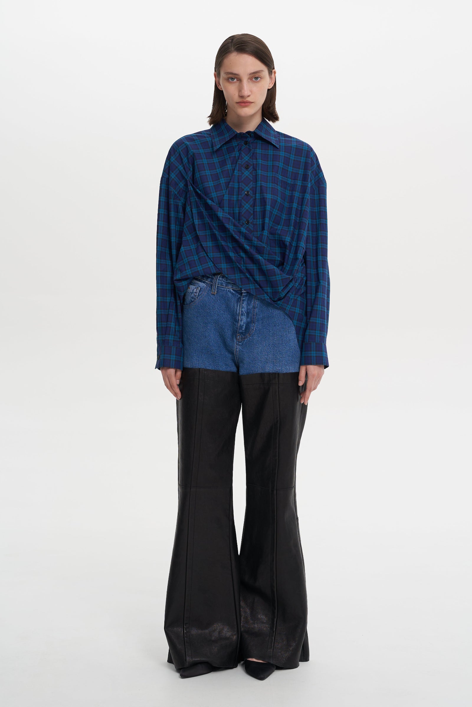 A person modeling a blue checkered shirt and black trousers. PRIME SHIRT BLUE 